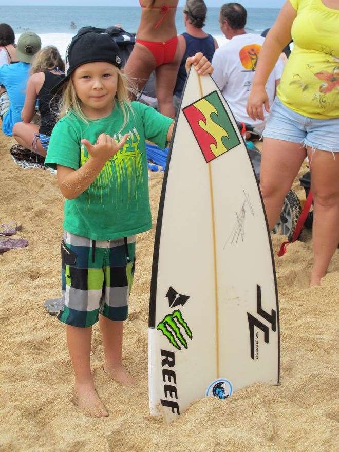 Stoked grom with half Shane Dorian’'s board